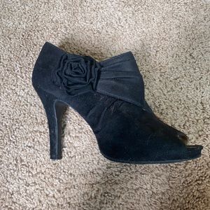 Black, velvet heels with rose accent. Size 6.